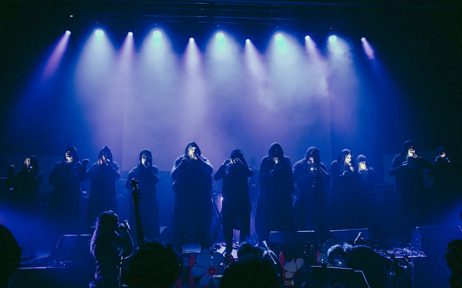 Growlers Choir in blue stage light.