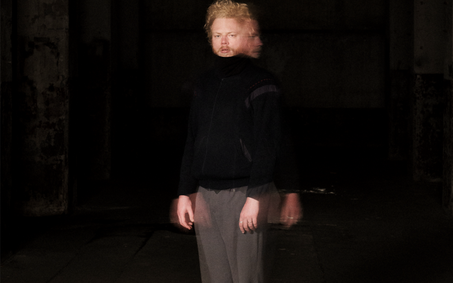 Lukas De Clerck in grey pants and black sweater.